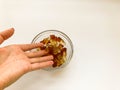 Fruit gelatinous sweets. jelly in the form of a bottle is poured from the hand into a round plate. dessert for children and adults