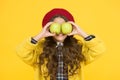 Fruit glasses. Little girl have fun with apples fruit yellow background. Small child hold healthy fruit. School snack Royalty Free Stock Photo
