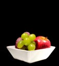 Fruit grape apple plum on a white plate Royalty Free Stock Photo