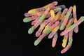 Fruit gummy candy worms on a dark background with space for text Royalty Free Stock Photo