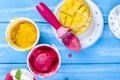 Fruit ice cream in buckets, on a blue wooden background and mango. Flut lay Royalty Free Stock Photo