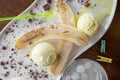 Fruit ice cream with fresh banana sprinkled with chocolate on white plate