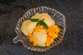 Fruit ice cream with fresh fruit slices with leaves mint on a glass plate. Royalty Free Stock Photo