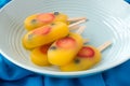 Fruit Ice Pops in a Blue Bowl on Blue Background