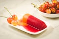 fruit ice and sweet cherry in a white bowl/fruit ice and sweet cherry in a bowl on a marble background. Selective focus Royalty Free Stock Photo