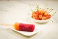 fruit ice and sweet cherry in a white bowl/fruit ice and sweet cherry on a white marble background. Selective focus Royalty Free Stock Photo
