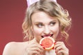 Fruit Ideas. Shy and Caucasian Blond Girl Biting Grapefruit
