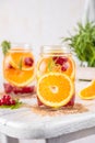 Fruit Infused Detox Water with orange red currants and rosemary