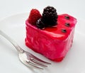 Fruit jelly cake and fork on the plate isolated on a white Royalty Free Stock Photo