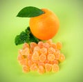 Ruit jelly  candies ,orange with leaf, spice, on a green Royalty Free Stock Photo