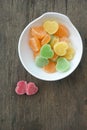 Fruit jelly hearts on wooden table