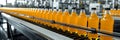 Fruit juice beverage production line on conveyor belt in a drink manufacturing facility