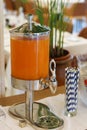 Fruit juice dispenser with paper straw on a self service breakfast counter in a hotel restaurant Royalty Free Stock Photo