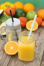 Fruit juice, in glass jar. Green background. Rustic wooden table. Healthy, vegan food and drinks Royalty Free Stock Photo