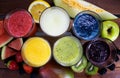 fruit juice or smoothies on wood seen from above Royalty Free Stock Photo