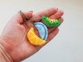 Fruit keychains lies on a woman's palm Royalty Free Stock Photo