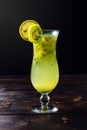 Fruit lemonade in hurricane glass with kiwi and lemon Royalty Free Stock Photo