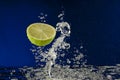 Fruit lime splash in water with bubbles Royalty Free Stock Photo
