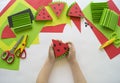 Fruit made of craft paper. Children`s hands