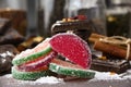 fruit marmalade sprinkled with powdered sugar next to chocolate and cinnamon.