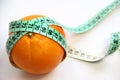 Fruit and measurement tape on the white background