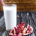 Fruit milkshakes with pomegranate in a transparent glass Royalty Free Stock Photo