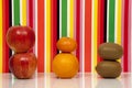 Fruit, multicolored background. Apple, orange, mandarin, kiwi.