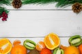 Fruit orange, tangerine and branch christmas tree cone on white wooden rustic background Royalty Free Stock Photo