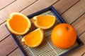 Fruit Oranges full and slice on plates and on wood table with lighting and shadow