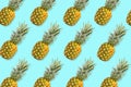 Fruit pattern of pineapples on a pastel blue background