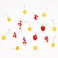 Summer pattern of red currants, ripe strawberries, yellow cherries isolated on light background