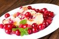 Fruit pie and cherries with raspberries on white plate Royalty Free Stock Photo