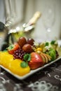 Fruit plate with apples, grapes, oranges, kiwis, strawberries