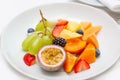 Fruit plate of fresh fruit slices for breakfast. On a white plate, passionfruit Royalty Free Stock Photo