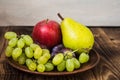 Fruit plate grapes apple plum pear Royalty Free Stock Photo