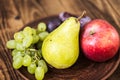 Fruit plate grapes apple plum pear Royalty Free Stock Photo