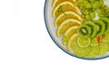 Fruit plate with grapes, kiwi, lime, pear and orange, sliced pieces on a white background, isolated Royalty Free Stock Photo