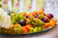 Fruit on a plate, grapes, plums and peaches. Buffet, Catering Royalty Free Stock Photo