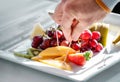 Fruit plate and hand taking treat