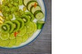 Fruit plate on table with grapes, kiwi, lime, pear and orange, sliced pieces on a white background, isolated Royalty Free Stock Photo