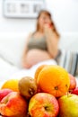 Fruit platter and pregnant woman in background Royalty Free Stock Photo