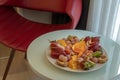 Fruit Platter on table with red chair Royalty Free Stock Photo