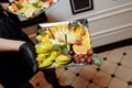 Fruit platter wonderfully decorated fruits conceptual fruit platter shots in the waiter`s hand luxury porcelain plate restaurant