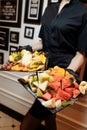 Fruit platter wonderfully decorated fruits conceptual fruit platter shots in the waiter`s hand luxury porcelain plate restaurant