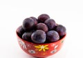 Fruit plum on a plate on a white background isolated close-up Royalty Free Stock Photo