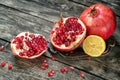 Fruit pomegranates and lemon on a wooden table close-up Royalty Free Stock Photo