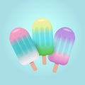 Fruit popsicles in pastel colors on blue background