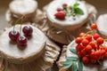 Fruit preserves and raw strawberries , cherries, rowans berries on a jars Royalty Free Stock Photo