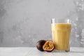Fruit protein shake on a white wooden table. Fresh milkshake with passion fruit. A glass of protein shake Royalty Free Stock Photo
