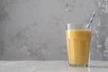 Fruit protein shake on a white wooden table. Fresh milkshake with passion fruit. A glass of protein shake Royalty Free Stock Photo